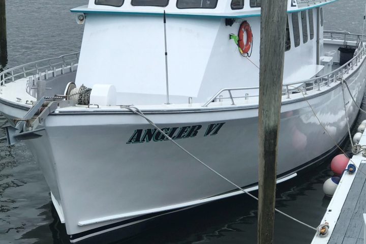 a boat is docked next to a body of water